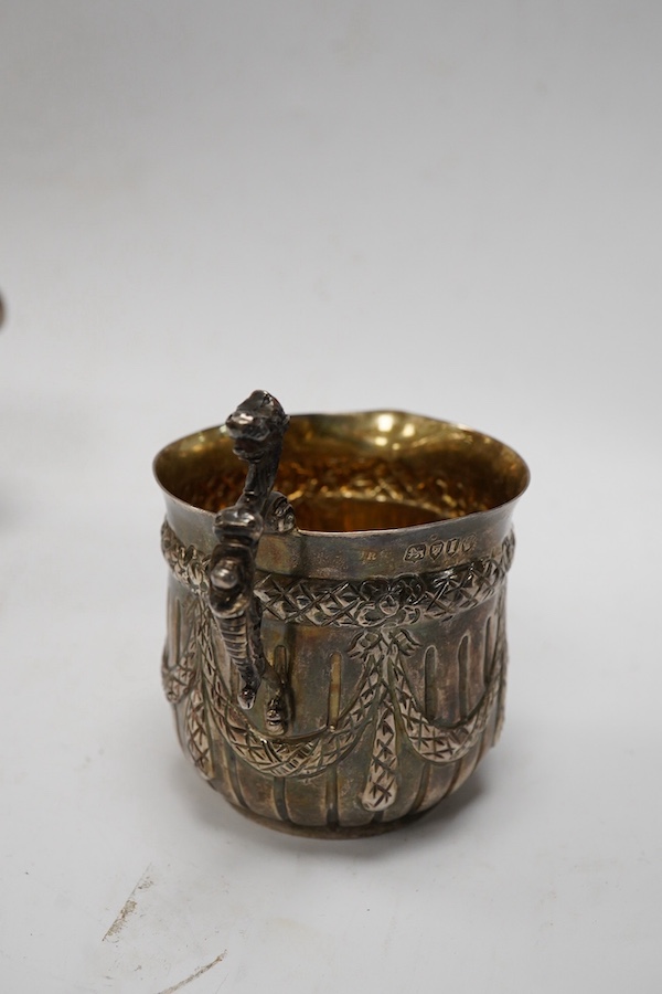 A Victorian silver cream jug, maker JR, London, 1884, together with a later silver sauce boat, pepperette and dish. Condition - poor to fair